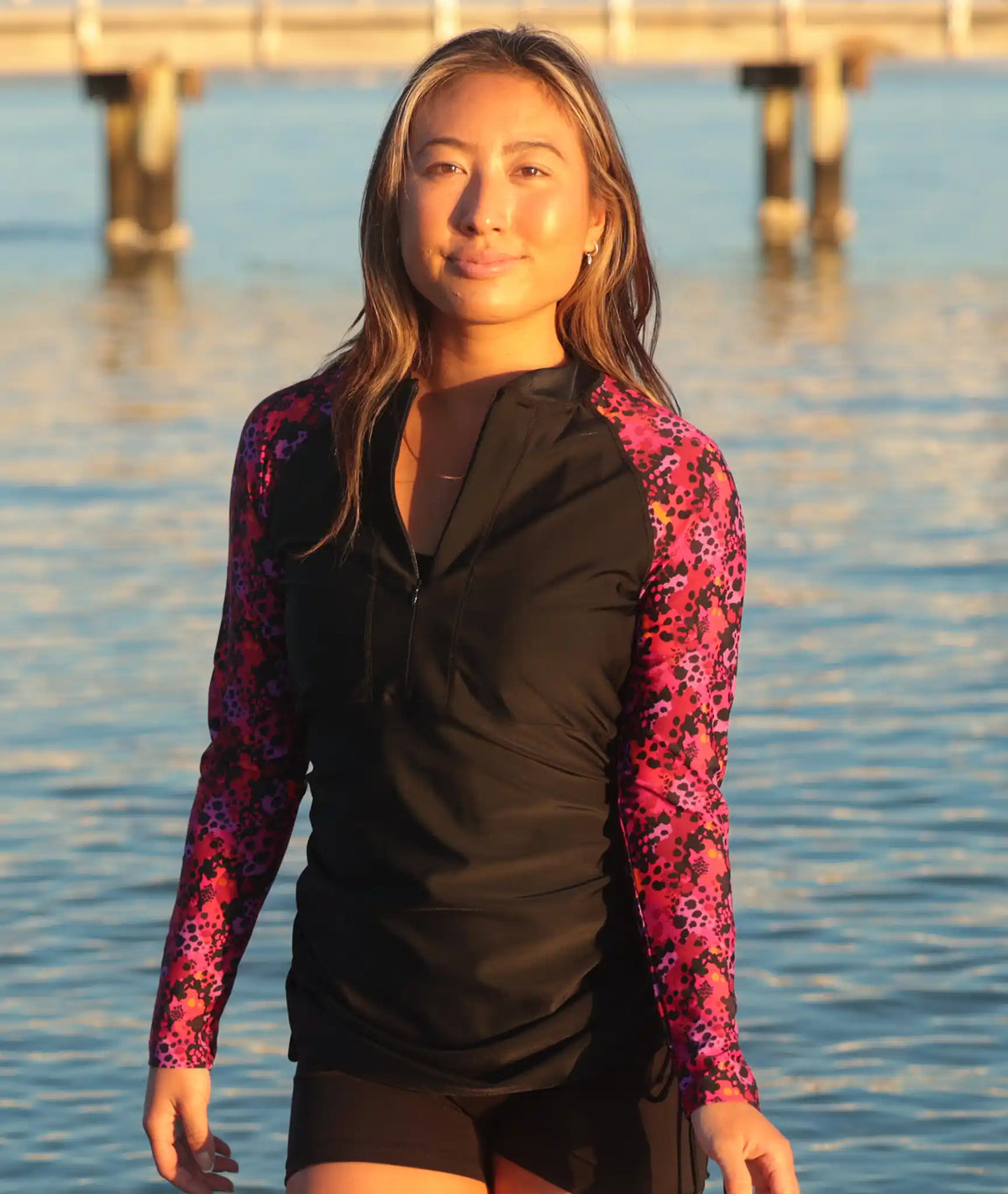 Black rash top with bright leopard print sleeves and zip neck