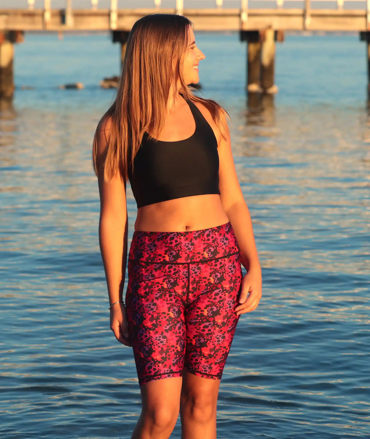 Black swim shorts with bright leopard print, finishing at the knee