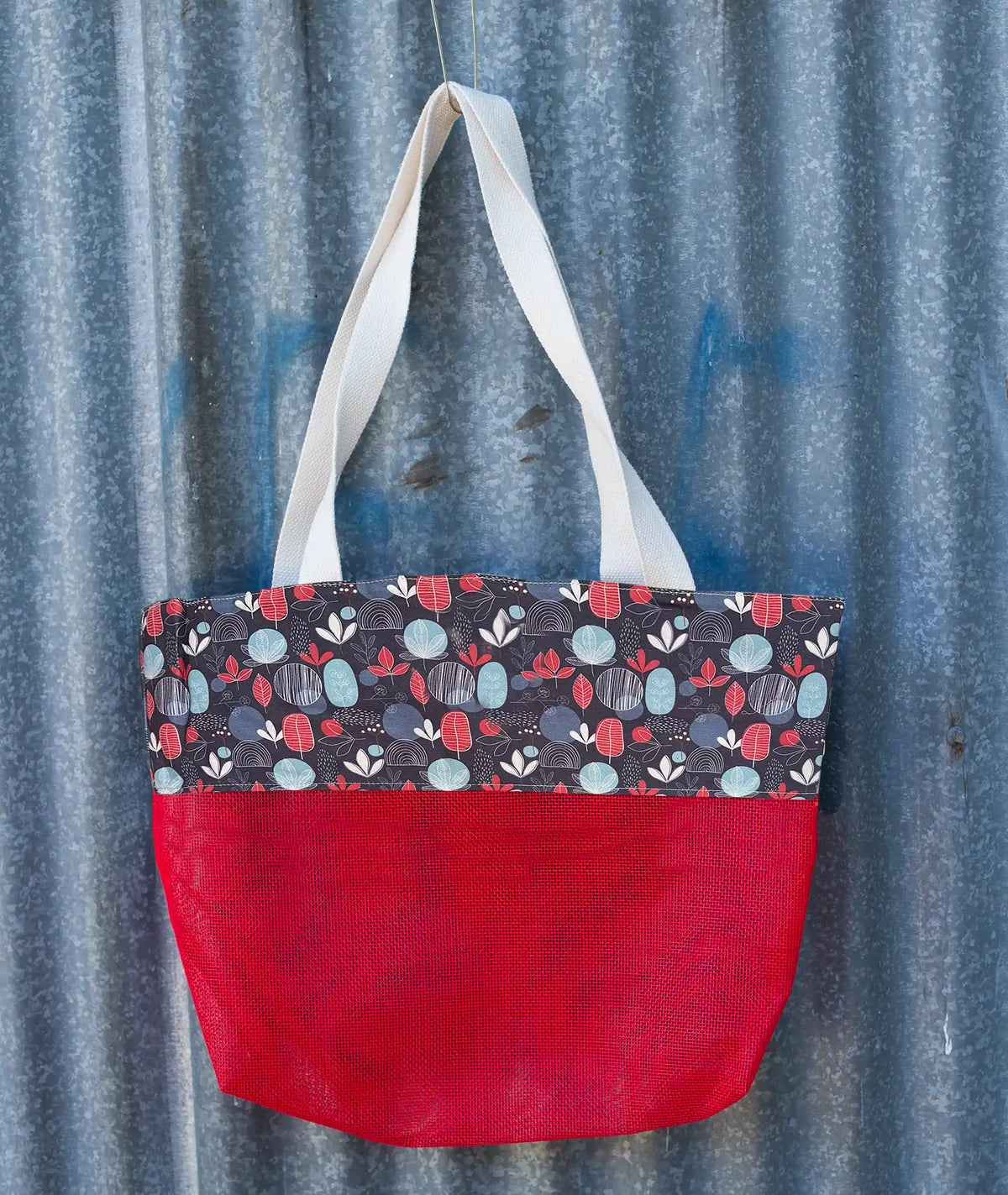Suncheeter Sandshaker sand free beach bag in red with a patterned panel and shoulder straps
